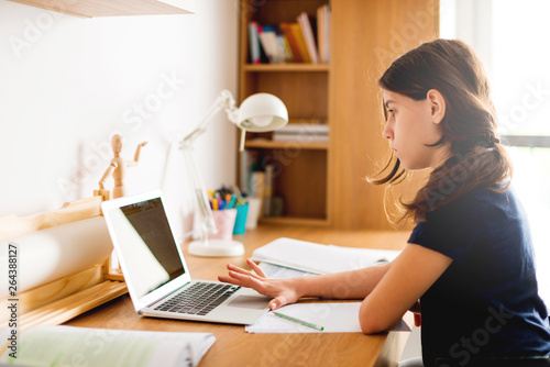 Teenage girl studying in her room