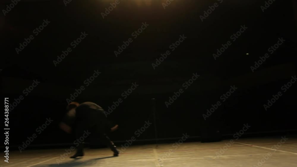 Young guy performs acrobatic elements in dance Young guy performs acrobatic elements in dance