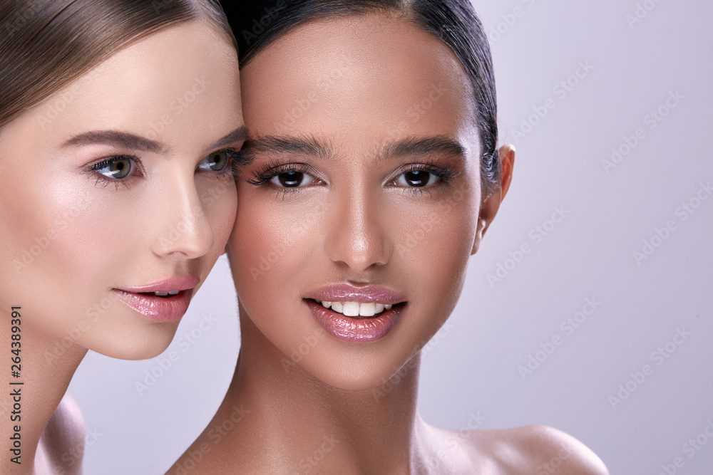 two girls with perfect make-up smiling two girls with perfect make-up smiling