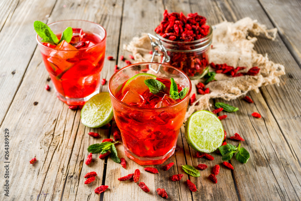 Homemade goji lemonade with lime and mint, rustic wooden background copy space Homemade goji lemonade with lime and mint, rustic wooden background copy space