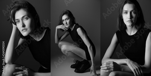 Fashion model. Young woman posing in studio wearing black drees and boots. Beautiful caucasian girl over gray background. black and white