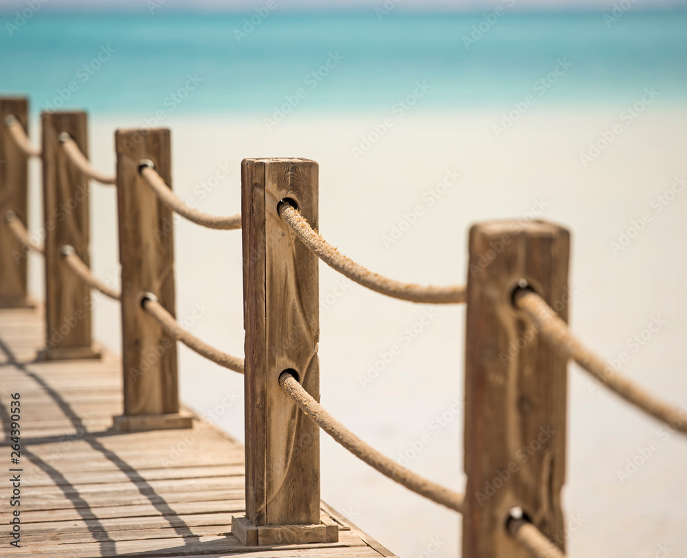 Wooden railings on jetty over tropical sea lagoon