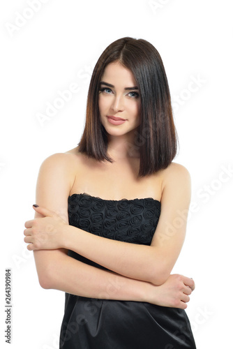Beauty. Portrait of attractive young woman over white background. Amazing girl wearing black dress with perfect makeup isolated on white background. © Khorzhevska