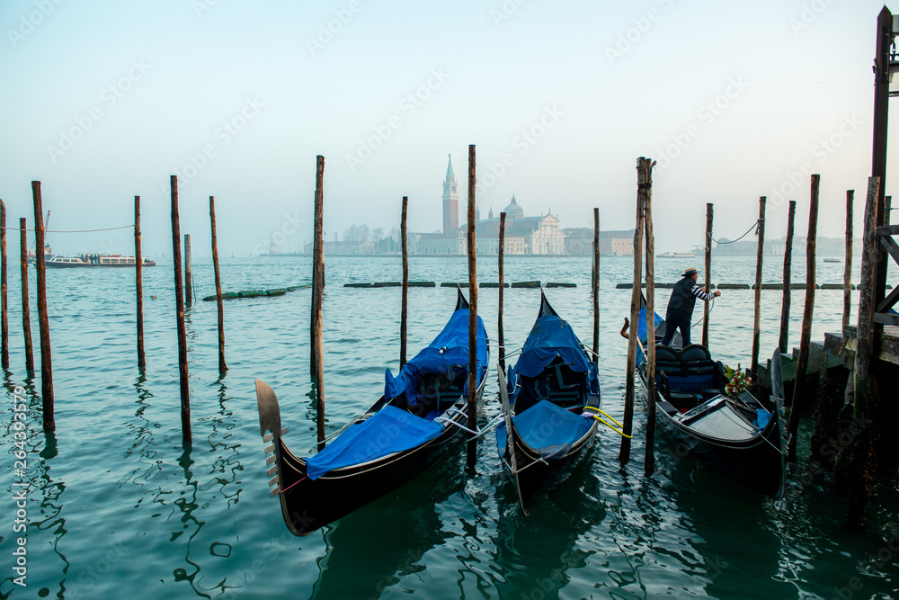 Grand Сhannel with gondola and gondolier, Venice, Italy. Beautiful ancient romantic italian city.