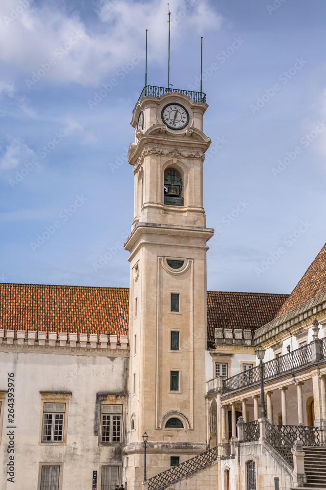 View of the tower building of the University of Coimbra, classic architectural structure with masonr and other classic buildings around, in Portugal