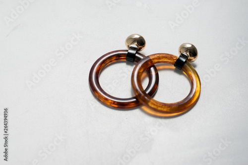 Fashionable plastic ring earrings eco-friendly background
