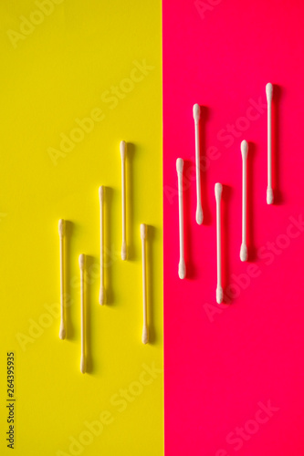 Cotton swab on a pink background.