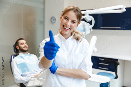 Happy young woman doctor in medical dentist center.