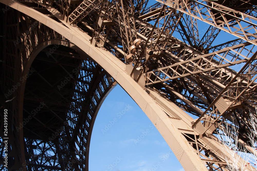 A photo from under the Eiffel Tower showing  its construction from  a different perpspective