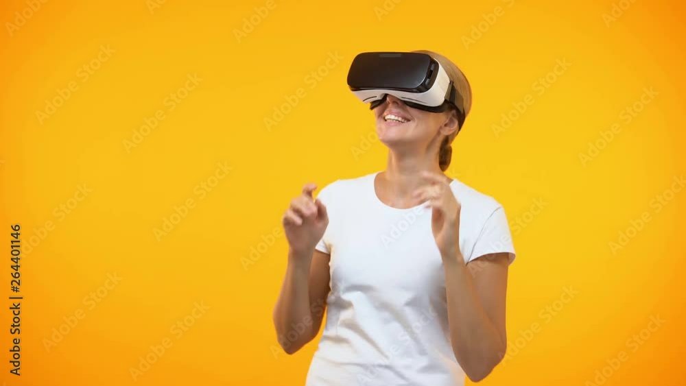 Excited young woman enjoying virtual reality wearing game headset, entertainment Excited young woman enjoying virtual reality wearing game headset, entertainment