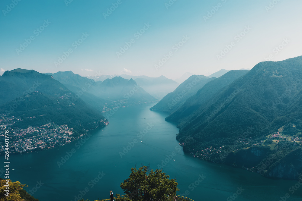 Aerial View on Alps and Lake Lugano on foggy morning. Switzerland.