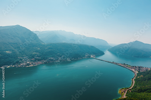 Aerial View on Alps and Lake Lugano on foggy morning. Switzerland.