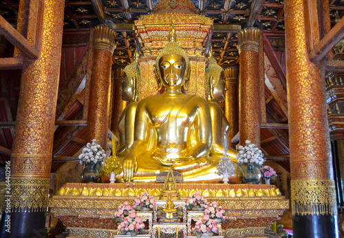 Golden Buddha statue in the attitude of Subduing Mara at Wat Phumin (Phumin temple) ,an ancient temple in Nan province,Thailand.