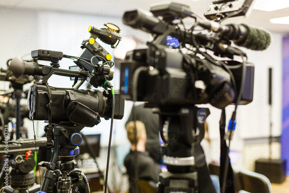The image of video camera under the tripod The image of video camera under the tripod