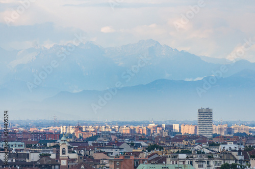 Milan city skyline with building and mountains seen on evening. Italy, Europe.