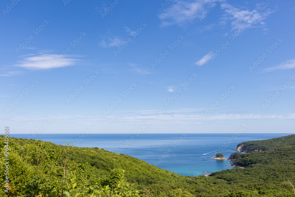 Summer seascape overlooking the green hills, rocky coast and the Japanese Sea Summer seascape overlooking the green hills, rocky coast and the Japanese Sea