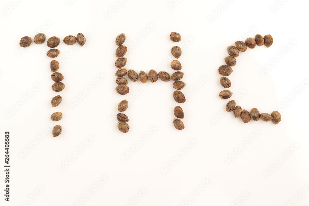 Hemp seeds on white background macro letters thc Hemp seeds on white background macro letters thc