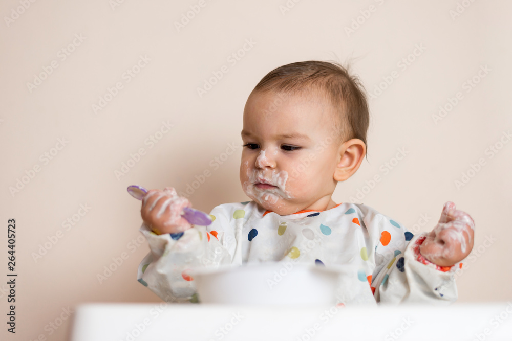 A Little baby eating her dinner and making a mess A Little baby eating her dinner and making a mess