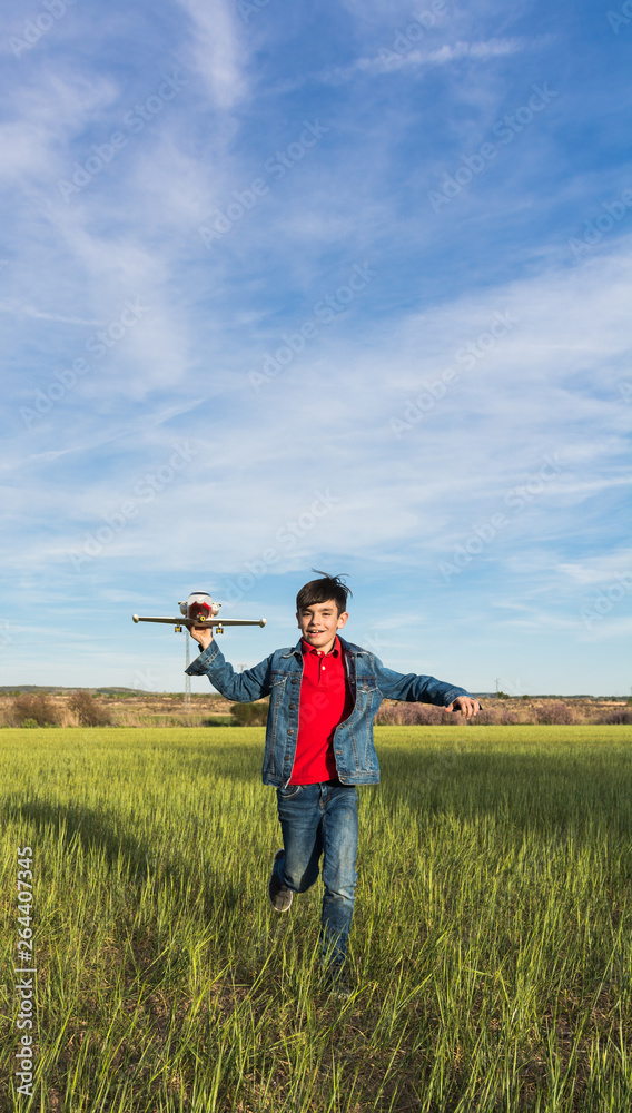 Boy running with a plane in a park. Boy running with a plane in a park.