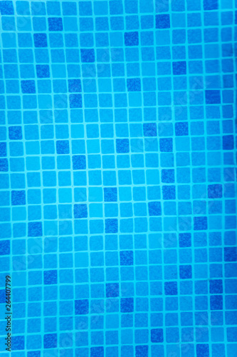 A fragment of blue pool tile, slightly distorted by invisible water