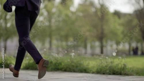 Wallpaper Mural Low section of businessman running on stairs outdoor. Cropped shot of man in brown shoes running on street, handheld shot. Business concept Torontodigital.ca