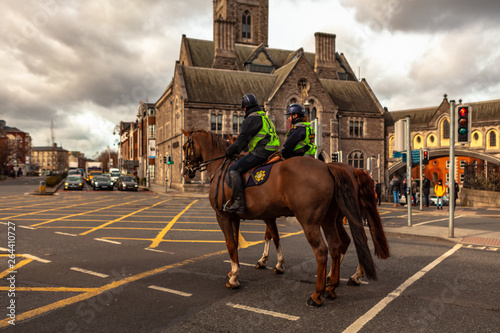 Wallpaper Mural Dublin, Ireland – March 2019. Policeman on crowd control horses near to Christ Church Cathedral in Dublin, Ireland Torontodigital.ca