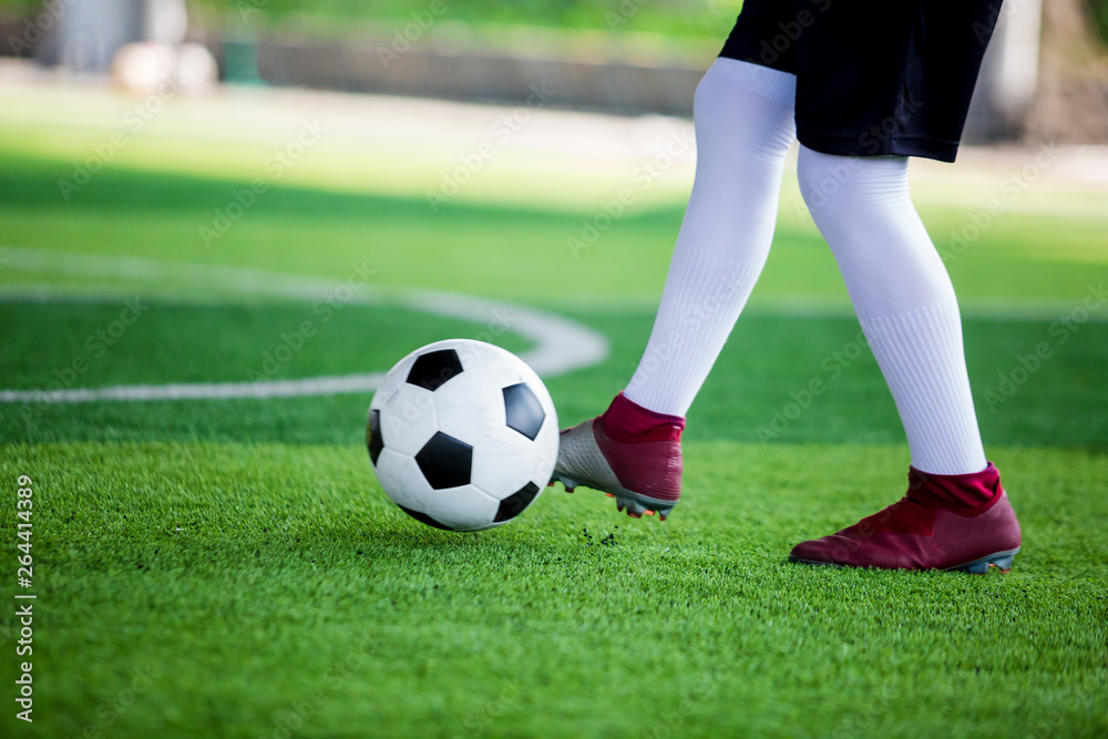 Soccer player speed run to control and shoot ball to goal on artificial turf Soccer player speed run to control and shoot ball to goal on artificial turf
