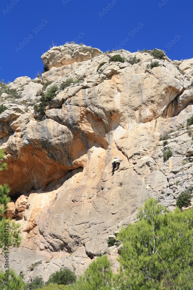 rock climber on sandstone rock face
