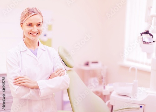 Happy woman dentist at her office smiling