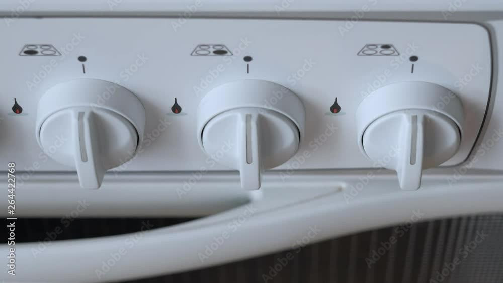 Man turn off gas stove gas. in the kitchen. Man turn off gas stove gas. in the kitchen.