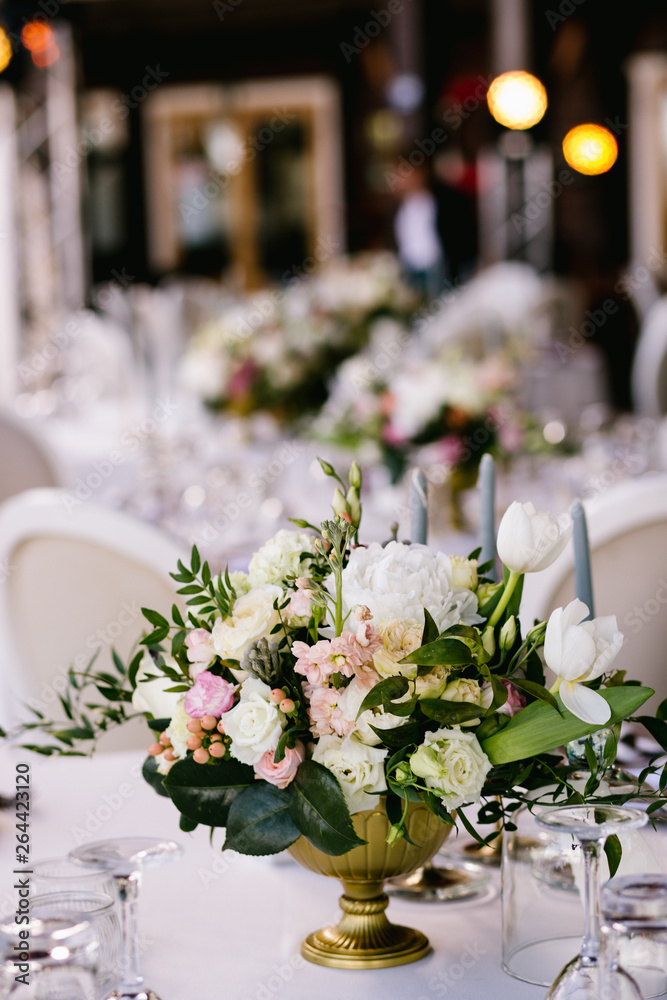 Flower arrangement on the table, wedding in summer Flower arrangement on the table, wedding in summer