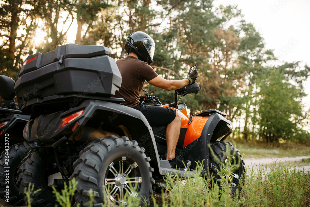 Fototapeta premium Rider in helmet on quad bike, front view, closeup