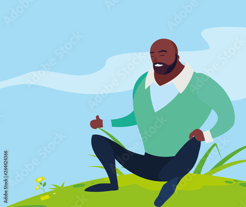 black strong and bearded man seated in the field