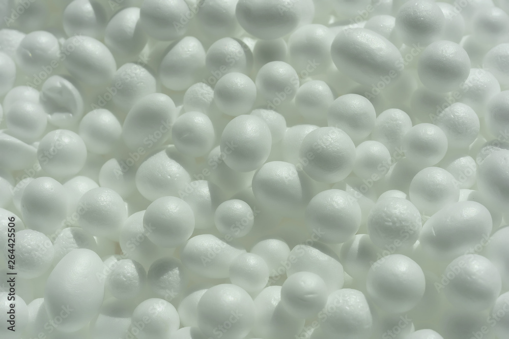 Texture of white foam balls. Abstract white background with round elements. Foam coat filler close up.