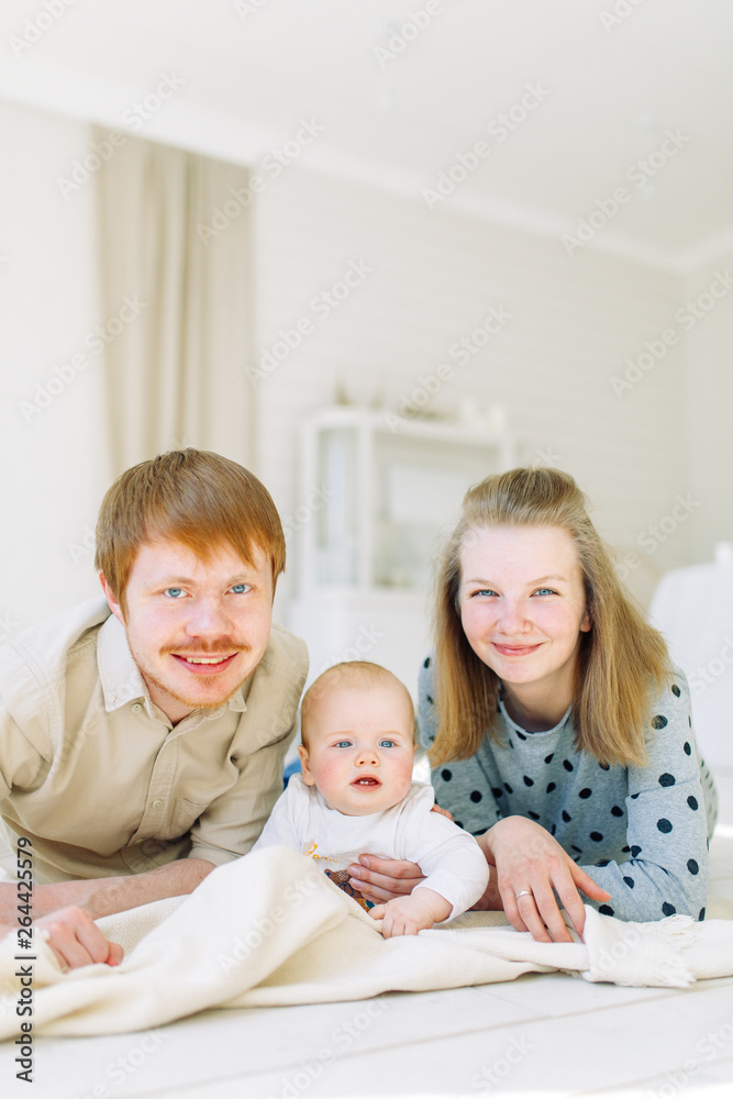 Photo shoot in the Studio, happy parents. Young family on a white background with the child. Photo shoot in the Studio, happy parents. Young family on a white background with the child.