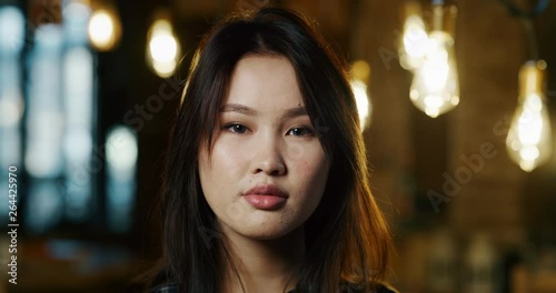 Wallpaper Mural Slow motion of close up of smiling friendly pretty young woman waiting her college friends in a bar. Shot in 8K. Concept of youth,friendship, leisure time Torontodigital.ca