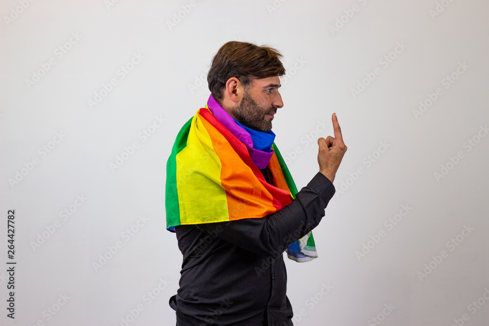 Portrait of handsome young man with gay pride movement LGBT Rainbow flag and brown hair covering the eyes, facing forwards and looking at the side. Isolated on white background. Portrait of handsome young man with gay pride movement LGBT Rainbow flag and brown hair covering the eyes, facing forwards and looking at the side. Isolated on white background.