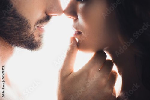 cropped view of man gently touching girlfriend isolated on white