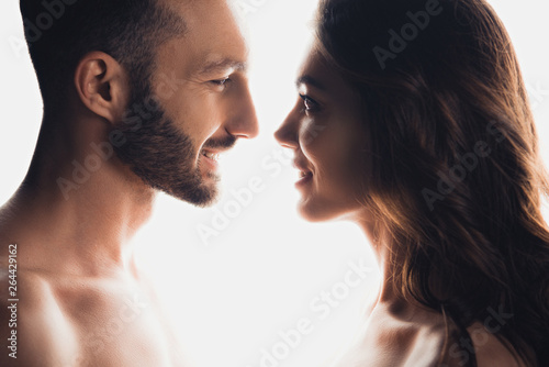 Side view of couple looking at each other isolated on white