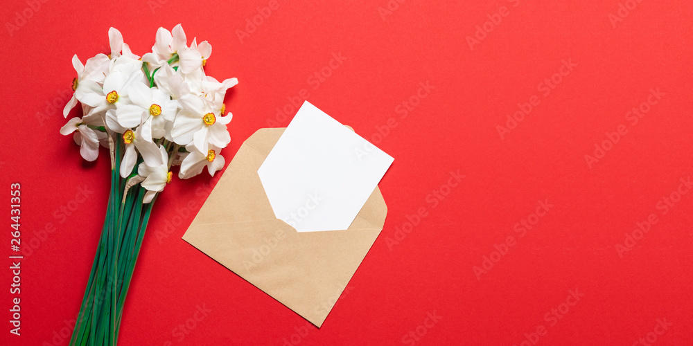 Letter, envelope in eco paper and red flowers on background. Letter, envelope in eco paper and red flowers on background.