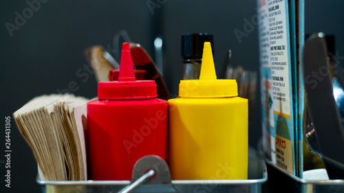 Фотография A close up of a traditional bottle of ketchup and mustard, this classic design o