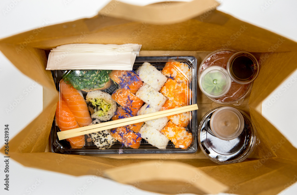 Sushi Take Away In Der Nähe Sushi to go concept. Top view of takeaway box with sushi rolls and