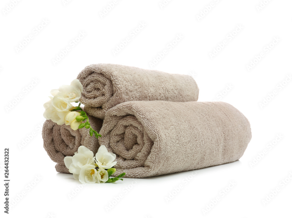 Clean rolled towels with flowers on white background Clean rolled towels with flowers on white background