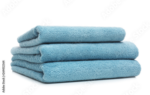 Stack of clean folded towels on white background