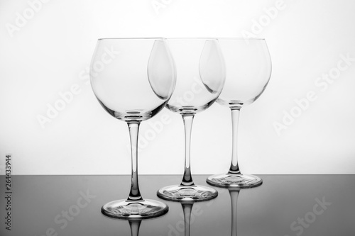 Row of empty wine glasses on white background