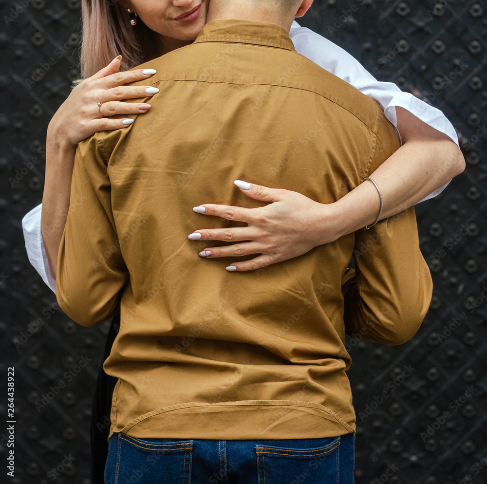 Female hands on male back
