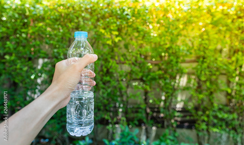 Hand holding fresh water bottle