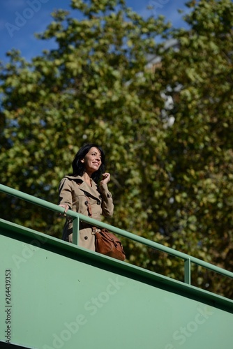 France, Paris - On a footbridge, a young Parisian woman is enjoying the sun