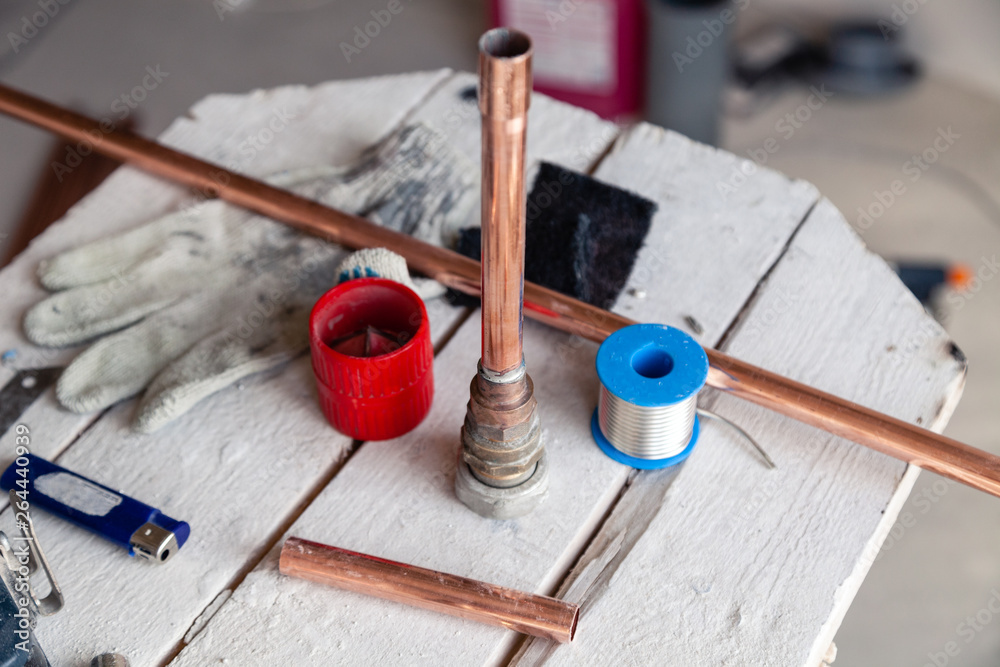 Closeup copper pipes, fittings, aluminum flux paste for solder for