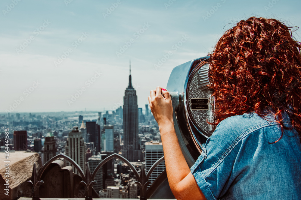 Young woman enjoying the New York skyline from high skyscrape in the morning. Travel photography - obrazy, fototapety, plakaty 